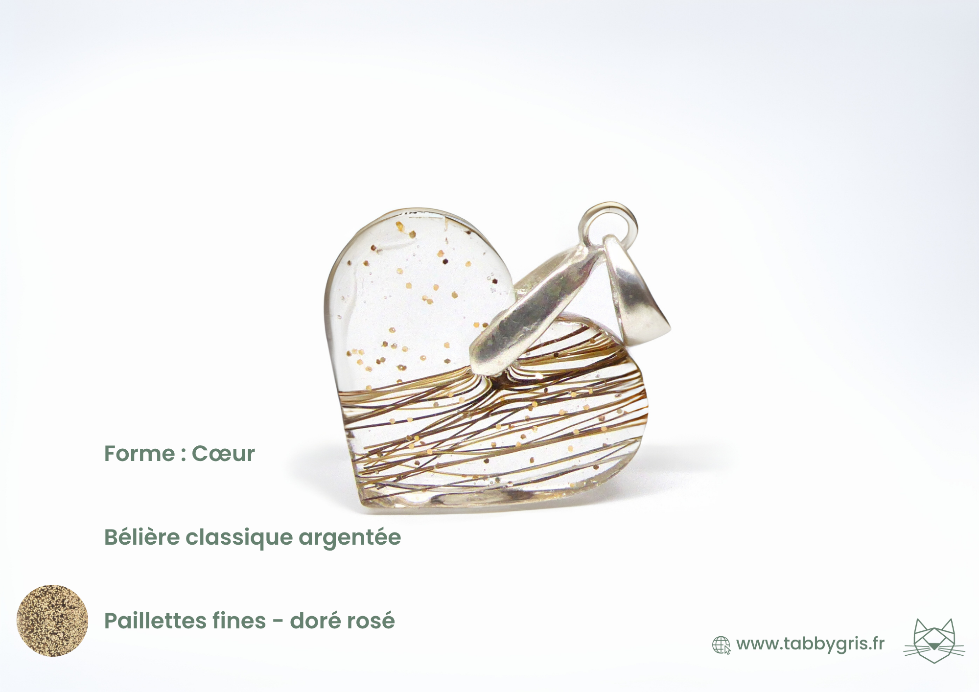 Pendentif poil animal en bijou en crin forme coeur avec quelques crins et paillettes fines dorées rosées.